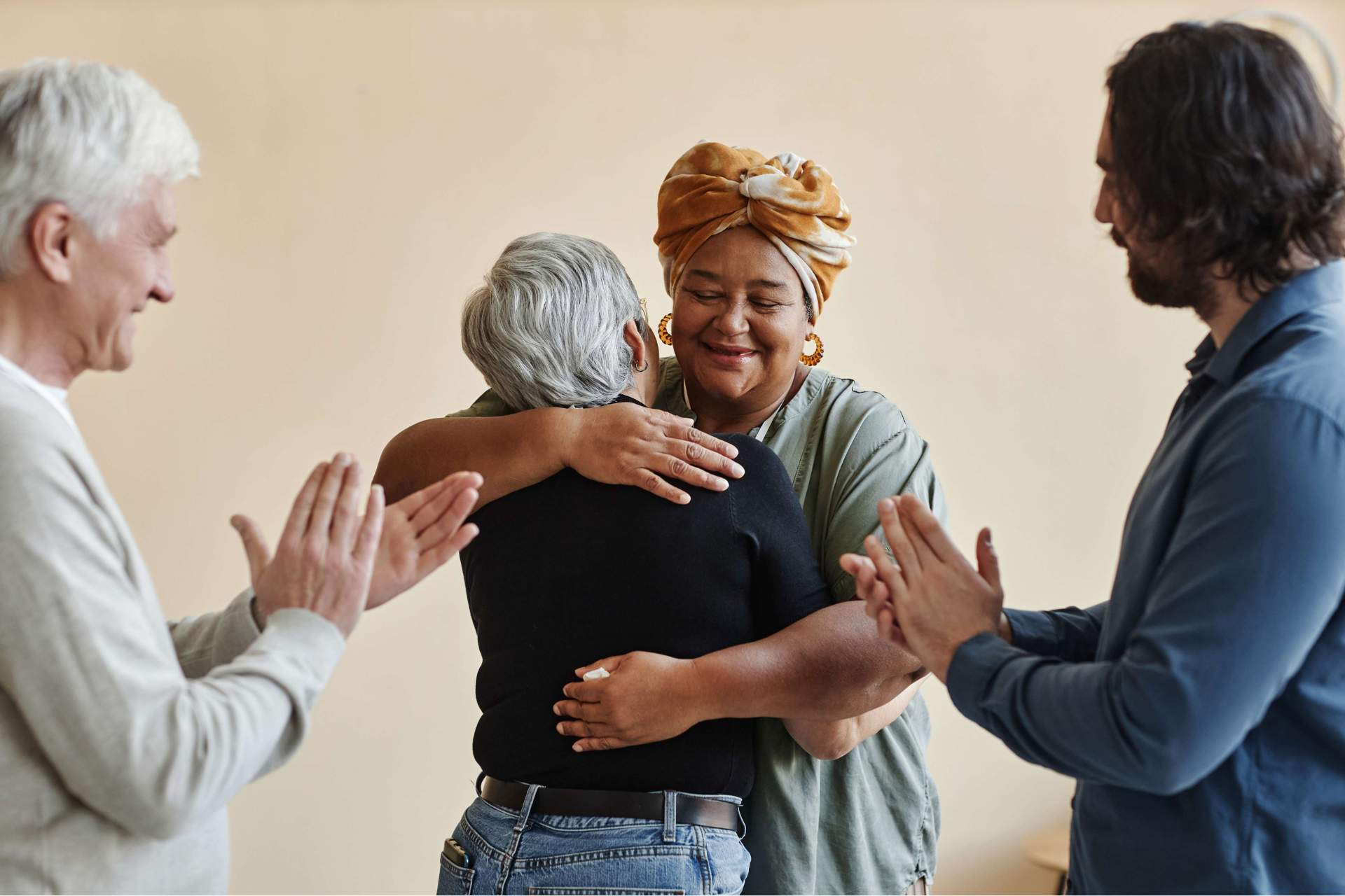 diverse group of elderly people embracing