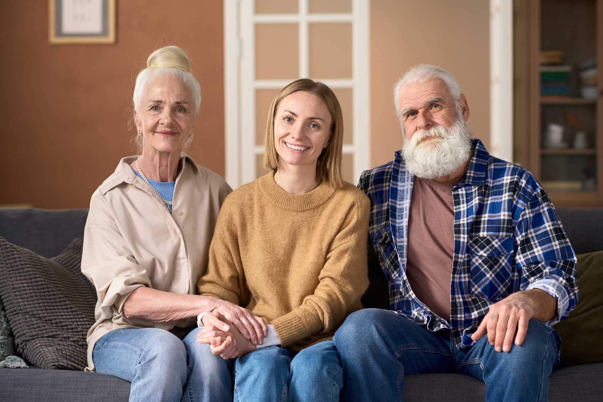 A daughter sitting between her senior parents